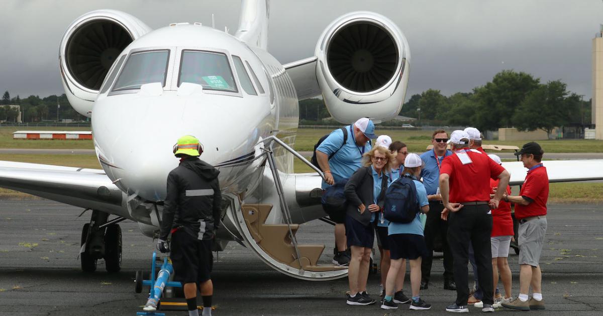 Coaches and athletes disembark from a Cessna Citation X on Saturday at Orlando Executive Airport in Florida to attend the 2022 Special Olympics USA Games. Their free transportation was arranged through Textron Aviation's Special Olympics Airlift. (Photo: Barry Ambrose/AIN)