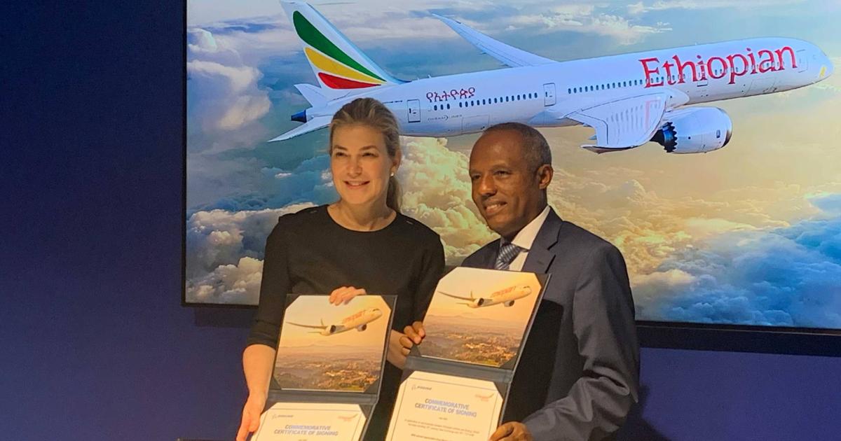 Stephanie Pope, president and CEO of Boeing Global Services, and Mesfin Tasew, global CEO of Ethiopian Airlines, announce an expanded services agreement covering landing gear and airplane health management.(Photo: Kerry Lynch/AIN)