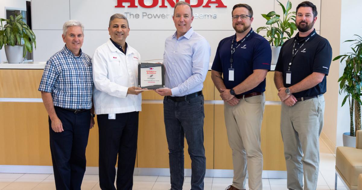 Hillsboro Aviation v-p and COO Ryan McCartney, third from left, receives the authorized service center plaque from Mr. Amod Kelkar, Honda Aircraft head of commercial business and v-p of customer service. (Photo: Honda Aircraft)