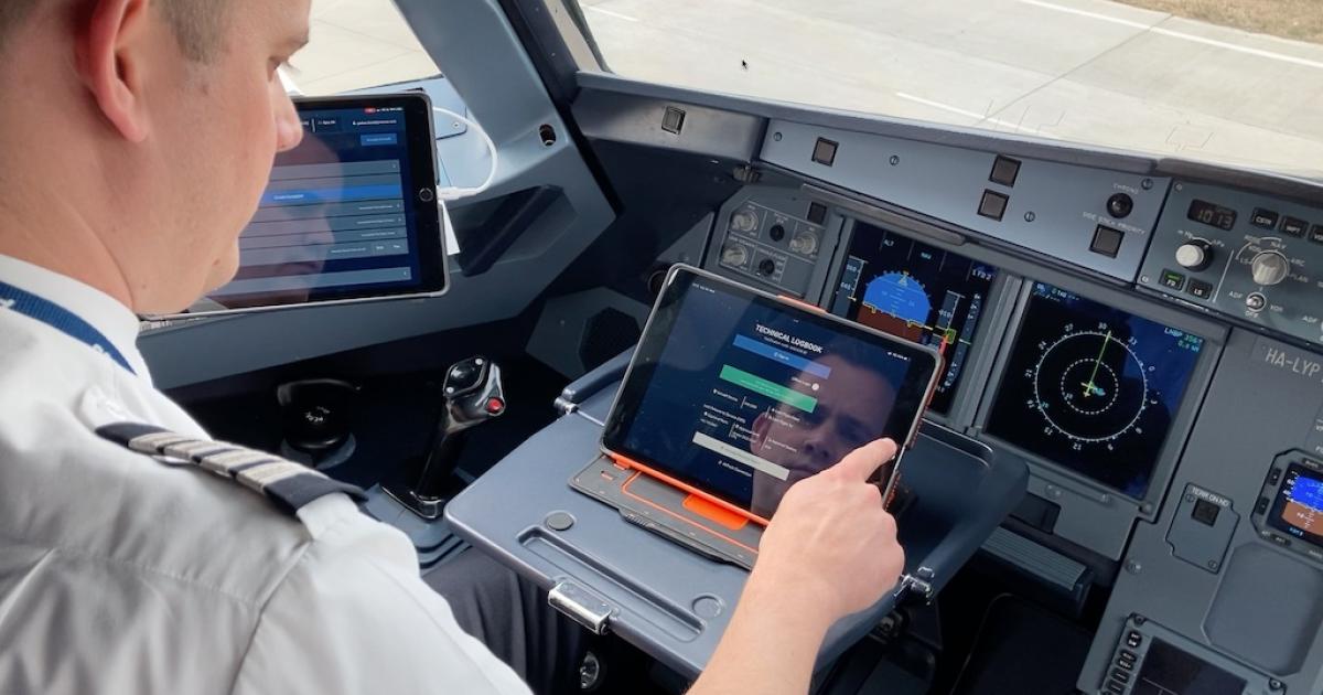 A Wizz Air pilot inputs data into an Aviatar electronic technical logbook. (Photo: Lufthansa Technik)