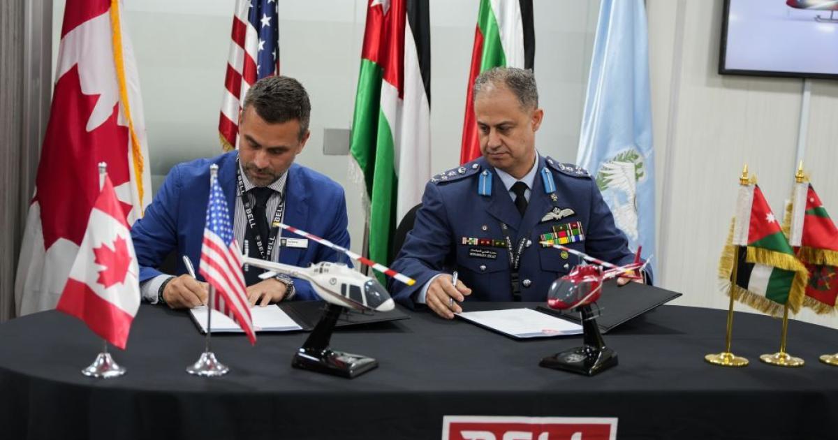 Patrick Moulay, Bell's senior v-p of International Commercial Sales (left), and Brigadier General Mohammad Hiyasat, Commander, Royal Jordanian Air Force, sign an agreement during the Special Operations Forces Exhibition & Conference in Aqaba, Jordan.