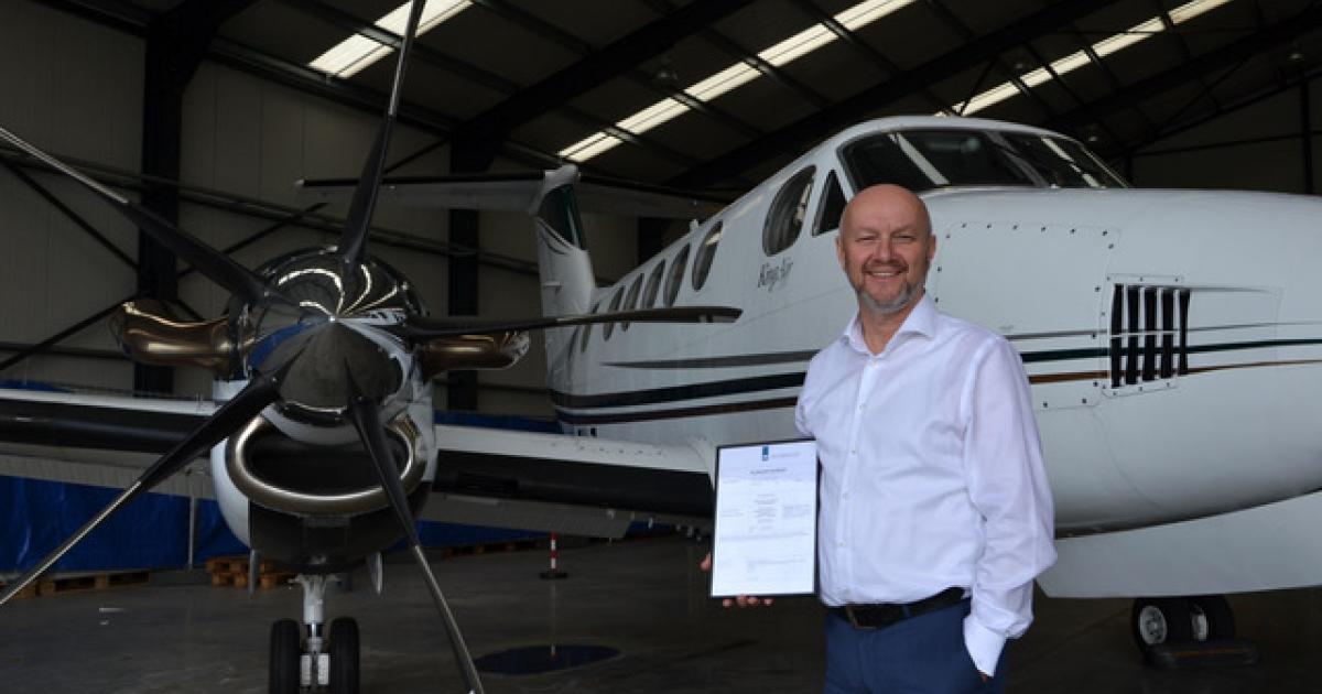 Zeusch Aviation managing director Herman van Kranenburg with the company's air operator certificate. (Photo: Zeusch Aviation)