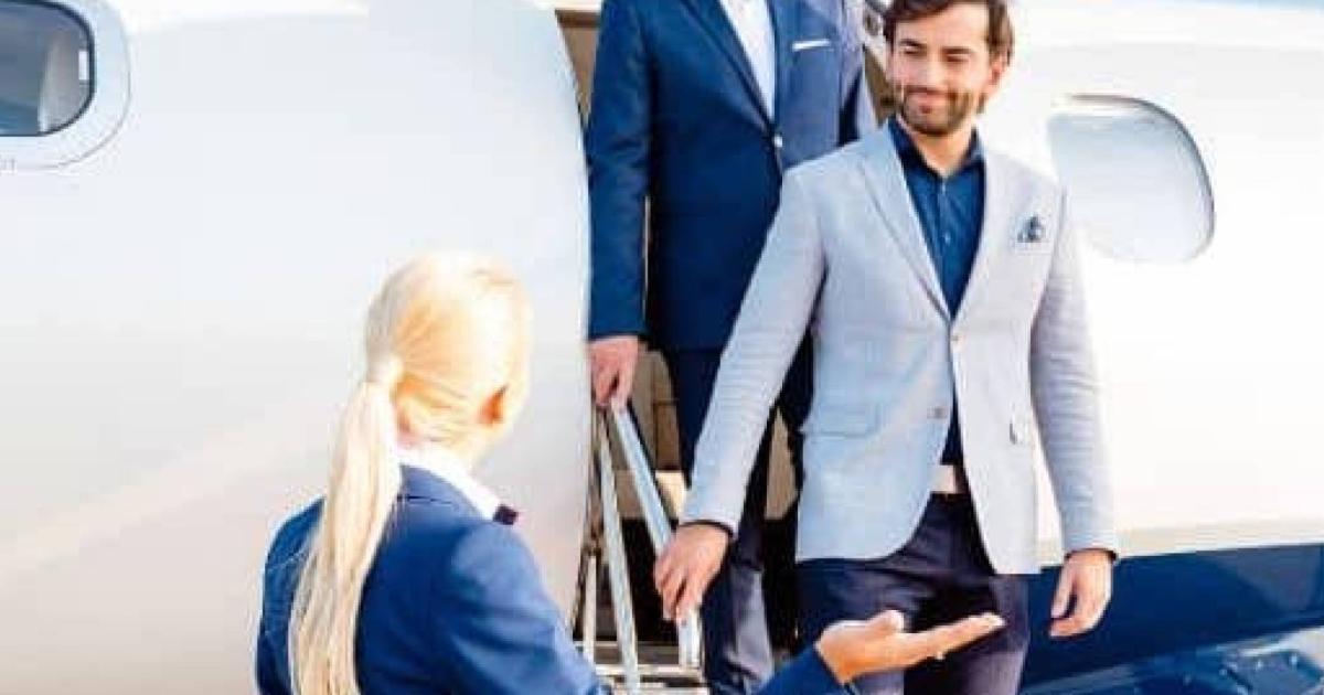 Passengers deboarding business jet greeted by cabin crew