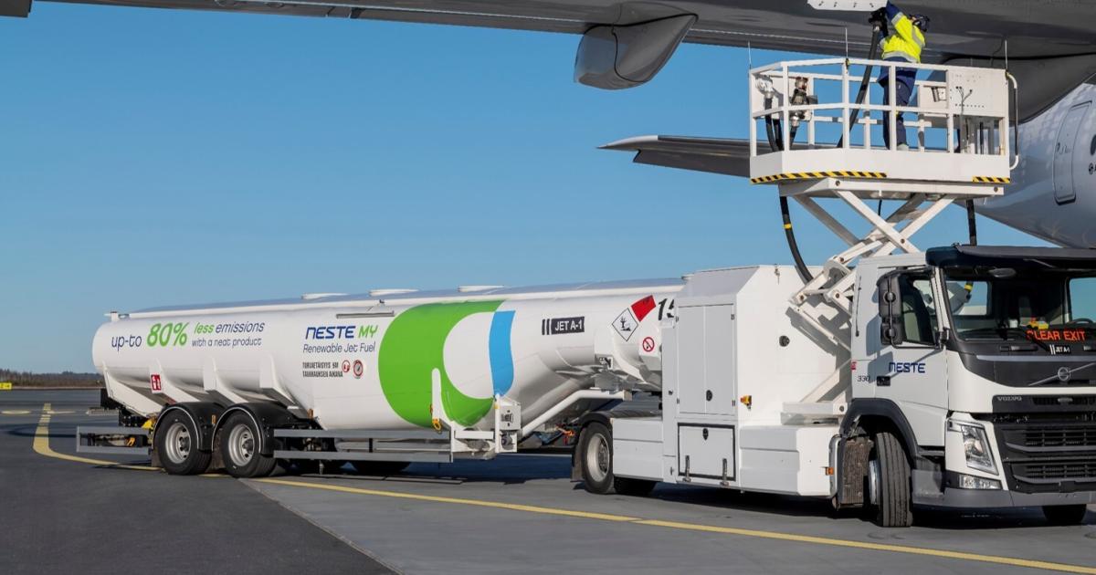 Neste SAF fuel tanker with lift refueling airliner under wing 
