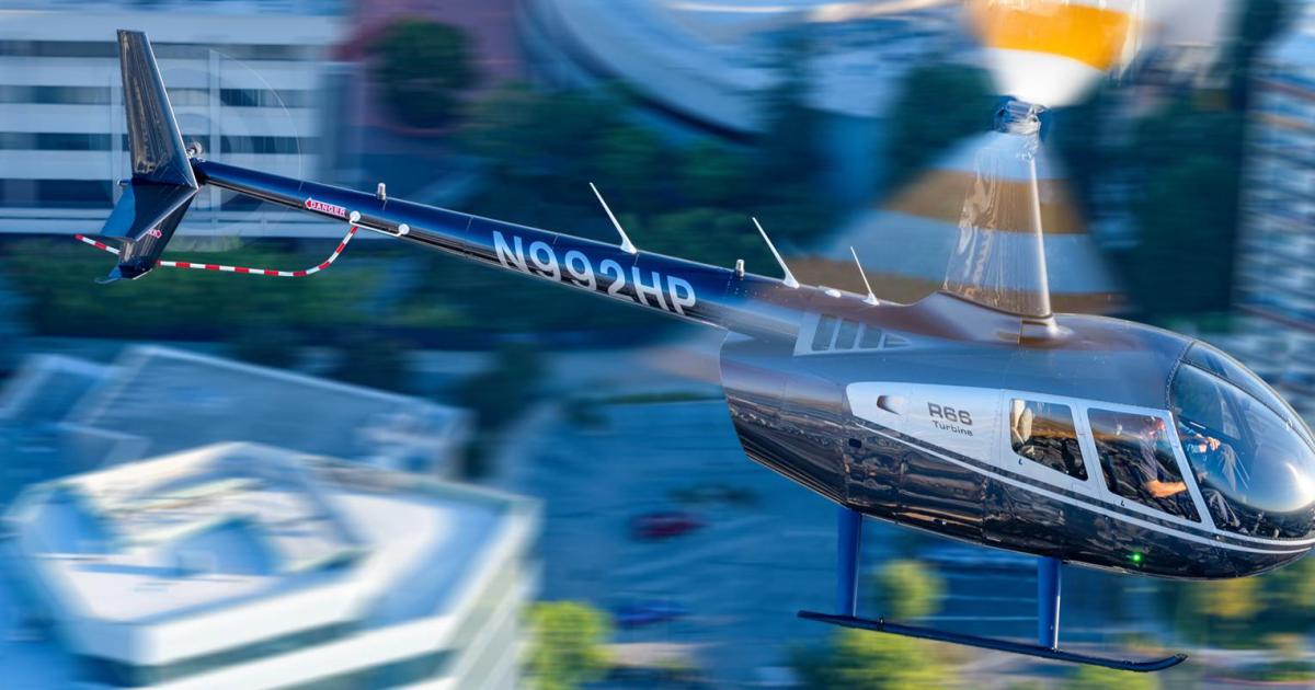 Robinson R66 helicopter in flight over city