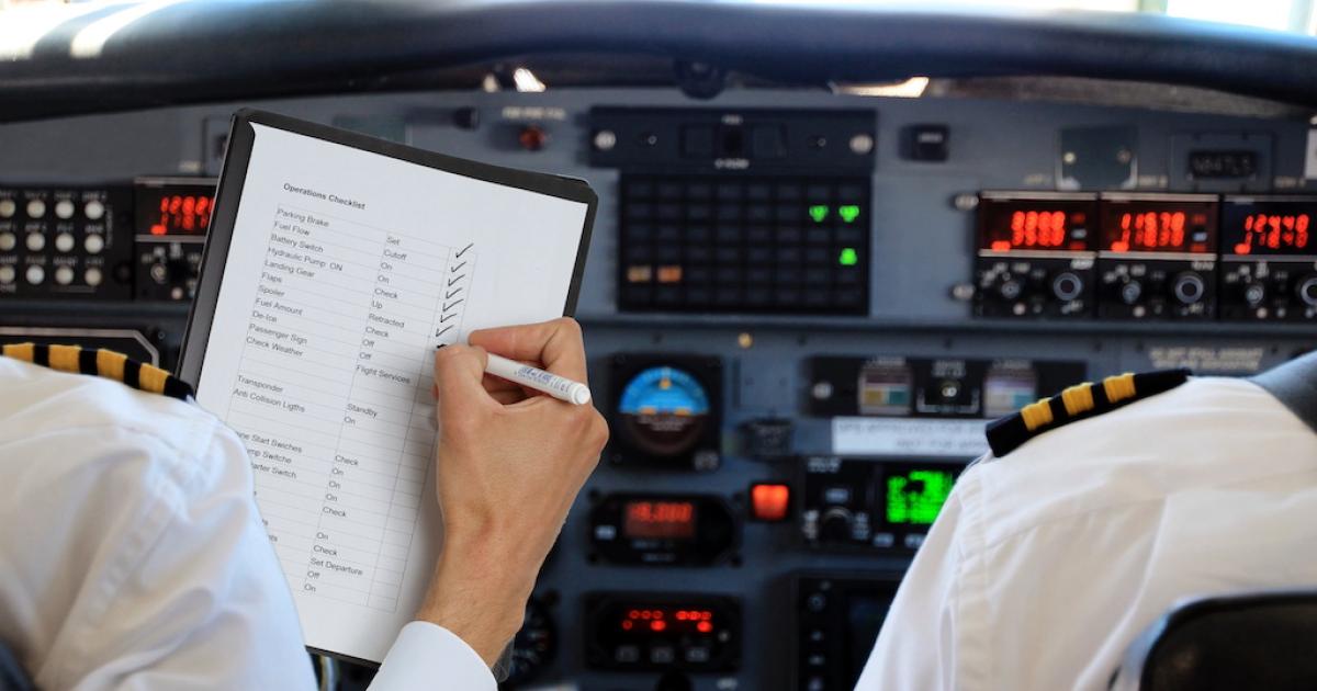 Pilots reviewing checklist in flight deck