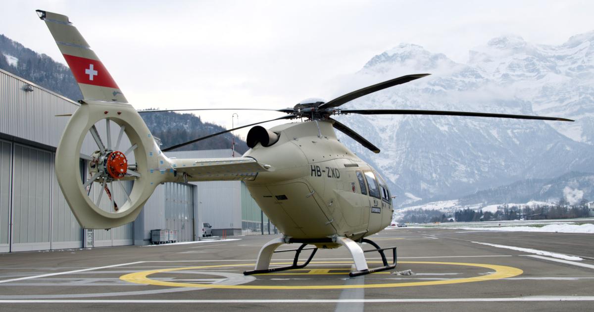 Leonardo AW09 single-turbine-engine prototype PS4 on helipad in front of hangars