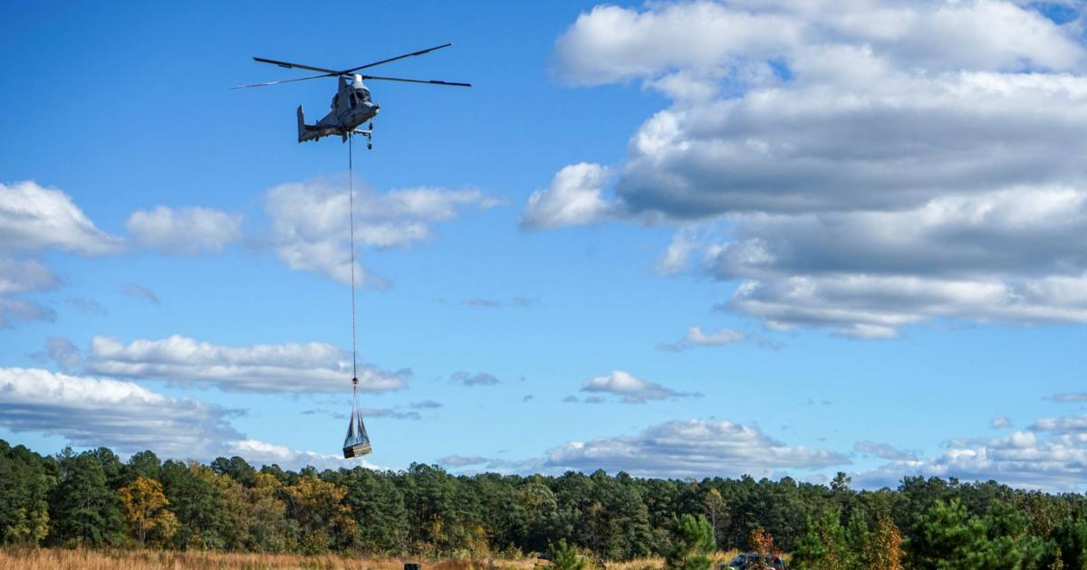 Kaman K-Max heavy-lift helicopter in flight carrying external load