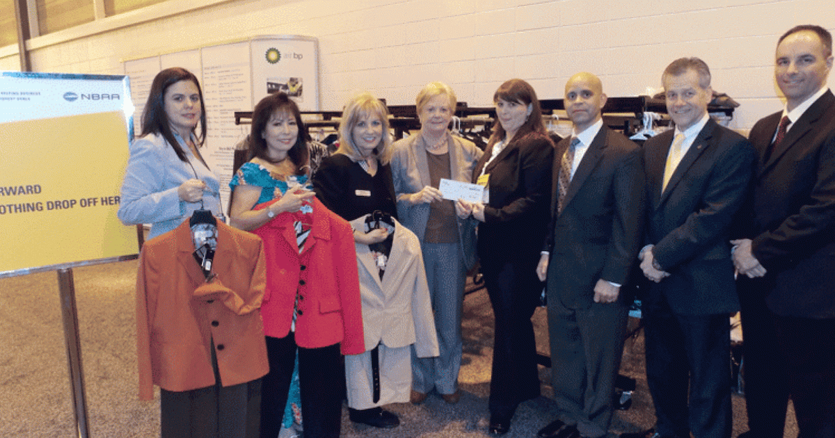 Spring Adamo (fourth from right) presents check to Midge Donald for Dress for Success New Orleans (Photo: Curt Epstein)