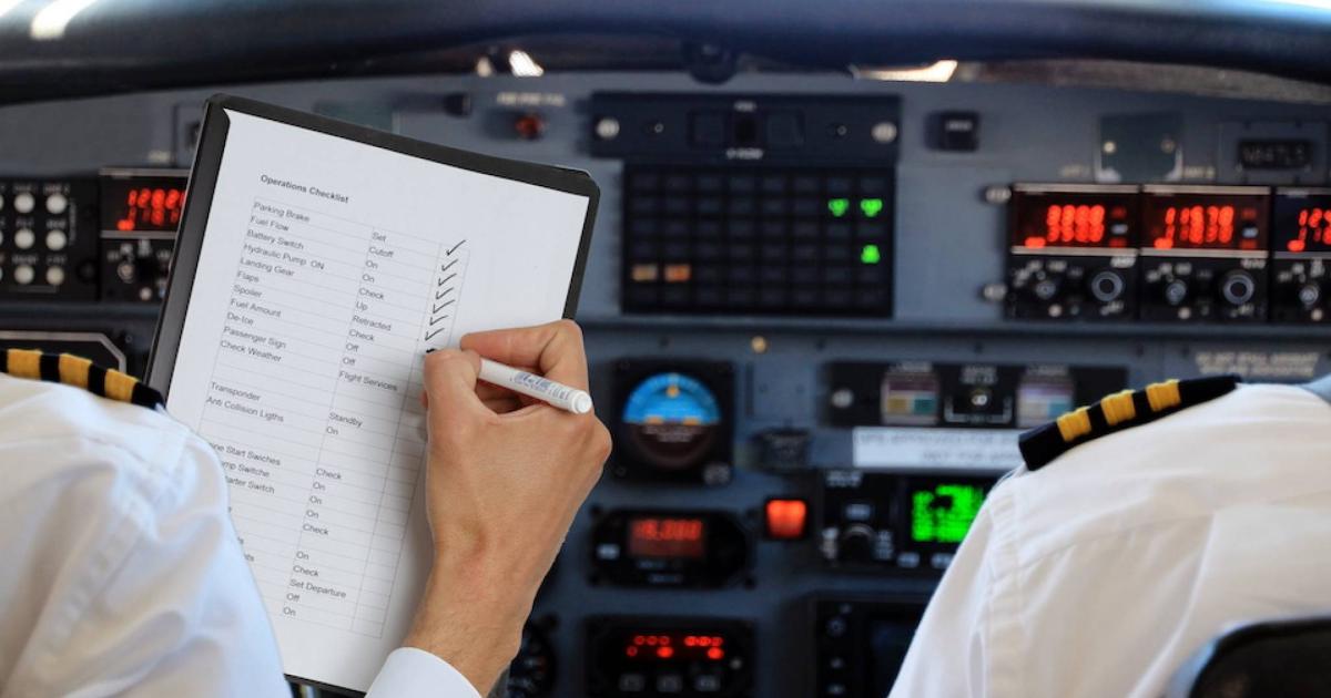 Pilots reviewing checklist in flight deck