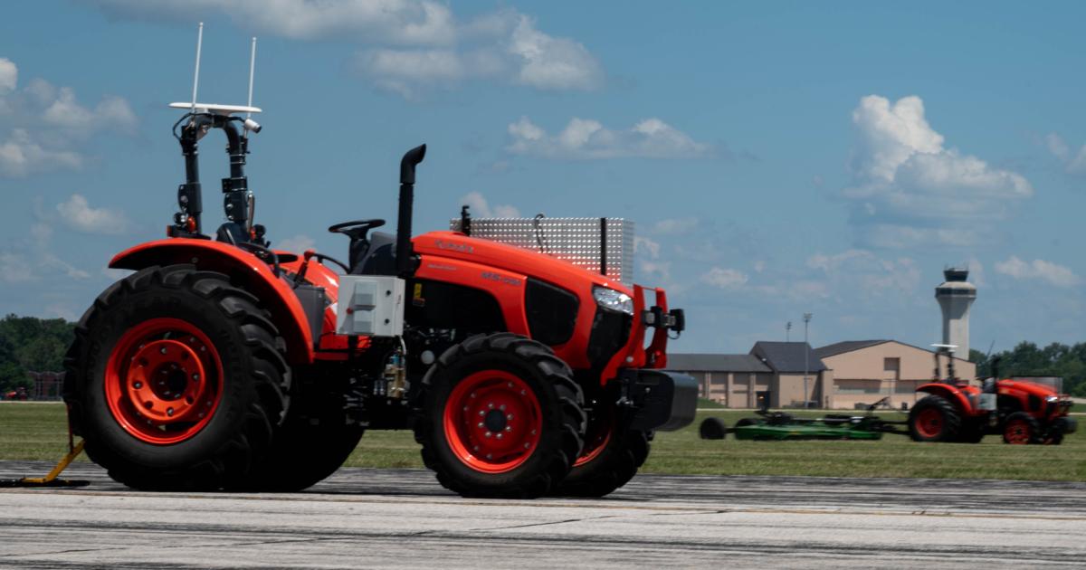 Autonomous tractors performing mowing and runway debris sweeps.