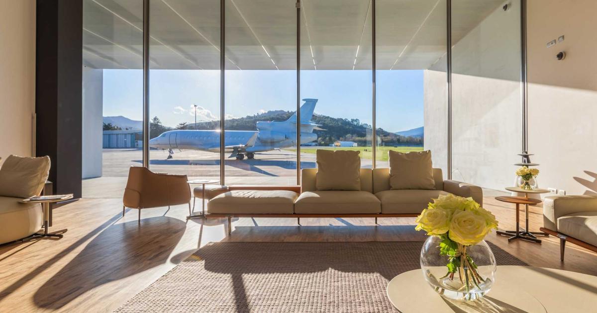 Lounge area at Hadid FBO at Italy's Riviera Airport overlooking airport ramp
