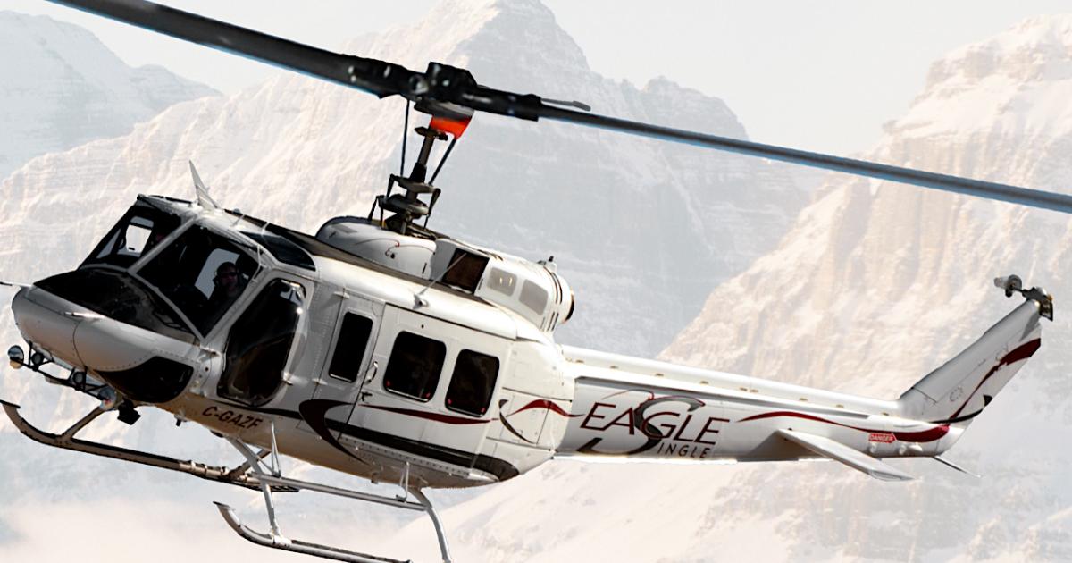 Eagle Copters Eagle Single helicopter in flight over snow-capped mountains