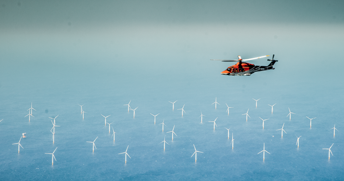 Helicopter above wind farm