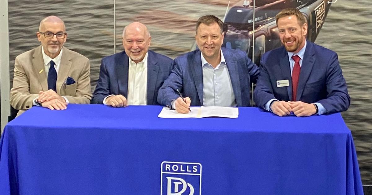 David Brulotte, Rolls-Royce First Network manager; Michael E. Guntner, president, Essential Turbines.; Michael F. Guntner, executive v-p, Essential Turbines and Scott Cunningham, Rolls-Royce program director for helicopters at signing table 