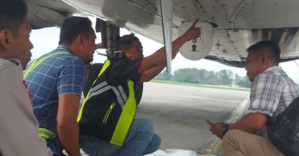 Indonesian investigators inspect a Trigana Air Boeing 737-500 for gunfire damage. 