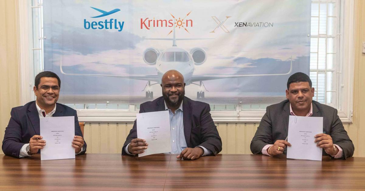 Nuno Pereira, Morry Davislaunch, and Ronaldo Alphonso at signing table with documents for joint venture BFK Aviation launch