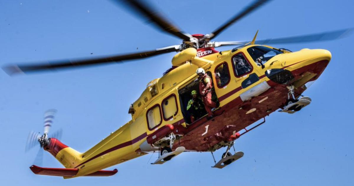 Med Rescue Agusta AW139 helicopter in flight with crew at open side door