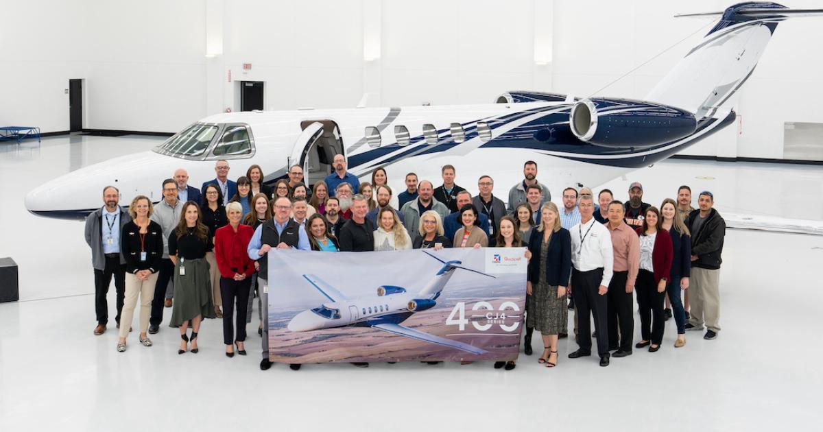 Textron Aviation Staff with banner celebrating the 400th delivery of a Cessna Citation CJ4 aircraft in background