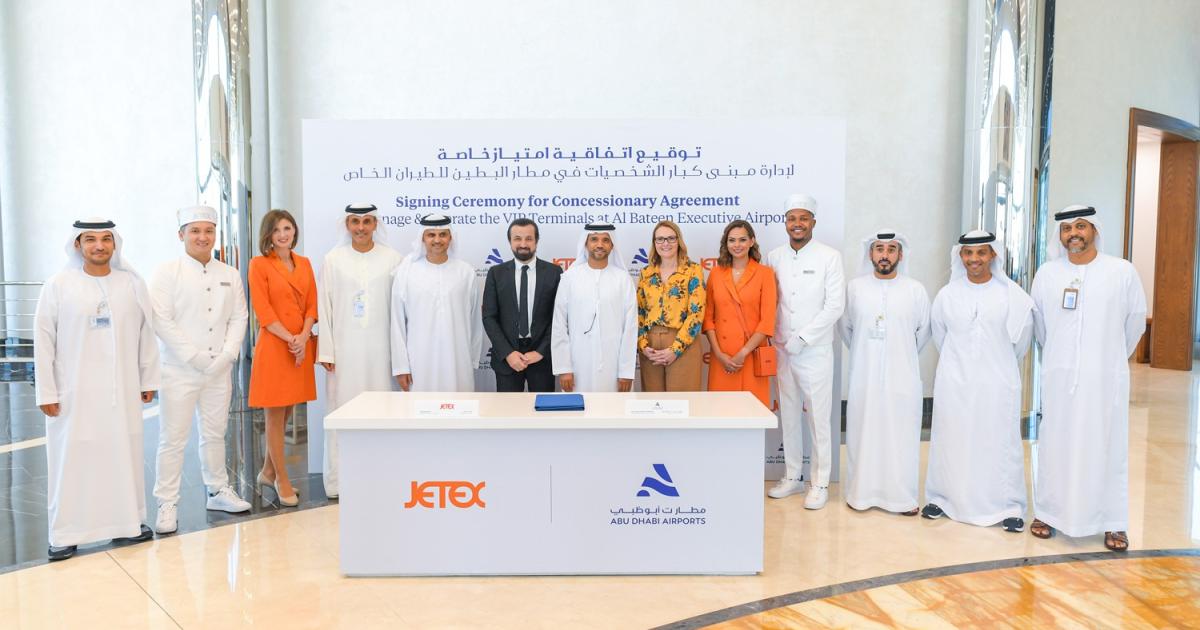 Jetex and Abu Dhabi Airports representatives at table during signing ceremony for concessionary agreement