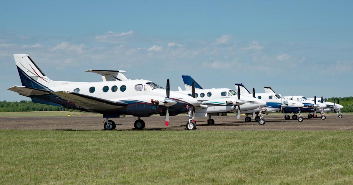 King Airs parked in a row on grass at an airfield during King Air Gathering 2023