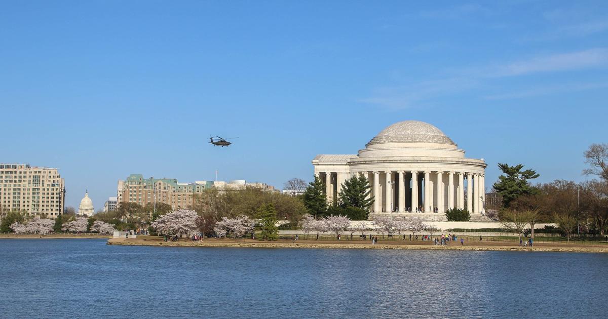 Military helicopter in flight over Jefferson Memorial in Washington D.C.