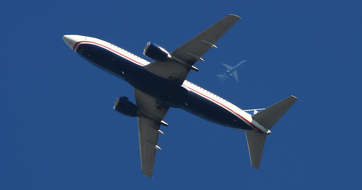 US Airways Boeing 737-300 in flight with another airliner overhead
