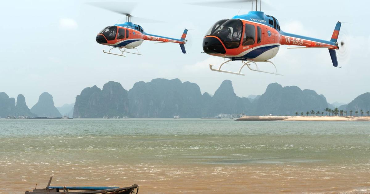 VNH Bell 505 helicopters in flight over Ha Long Bay in Vietnam