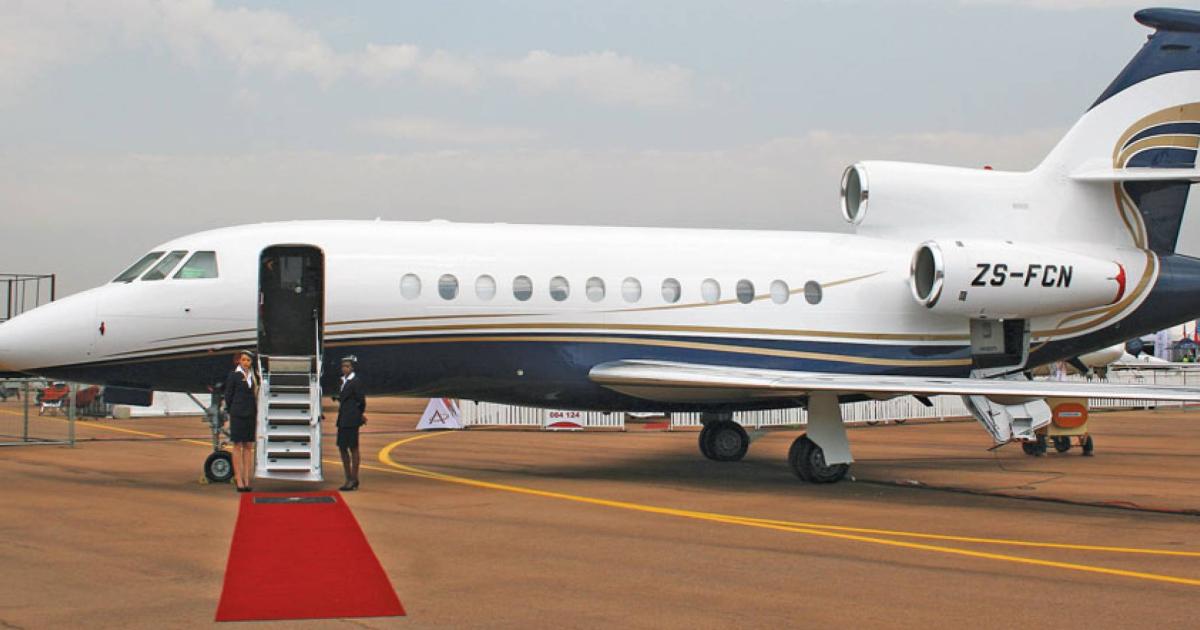 Dassault Falcon on airport ramp with door open and red carpet