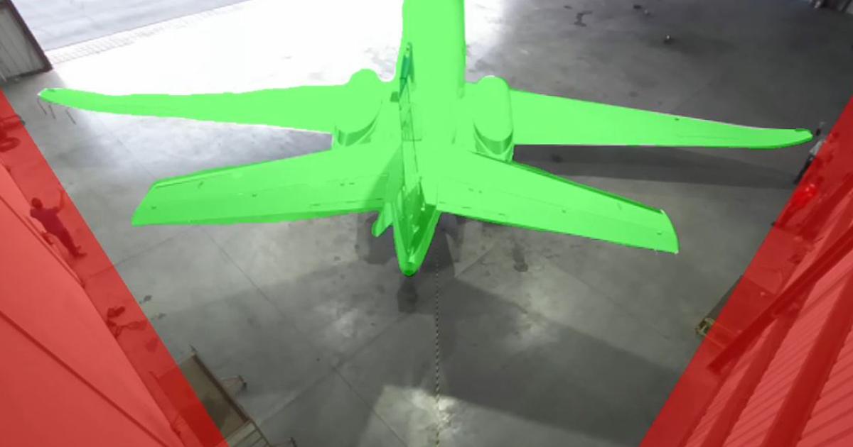 Rendering of business jet in hangar highlighted in green with hangar walls highlighted with red