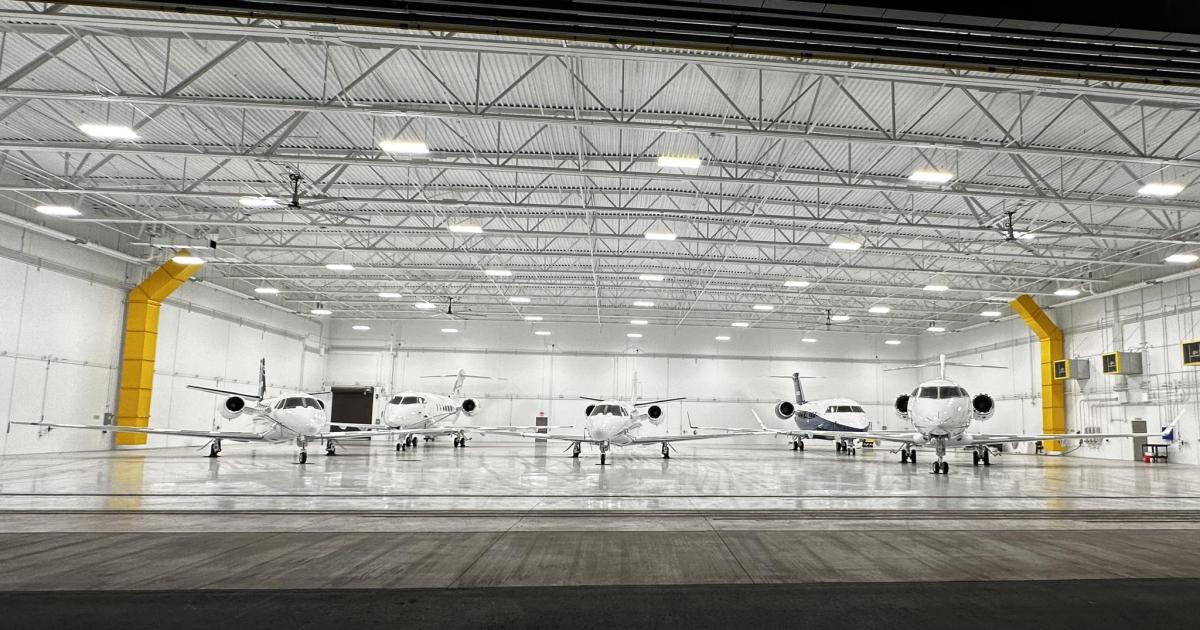 Jet Linx business jets in hangar at night 