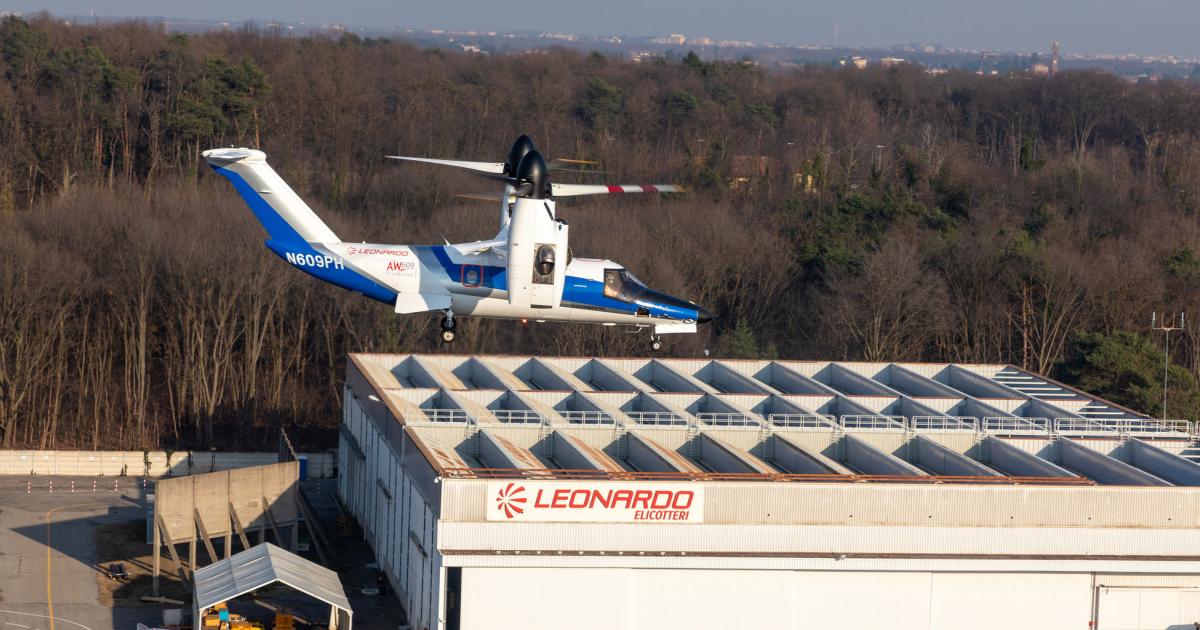 Leonardo AW609 tiltrotor  in flight over company hangar