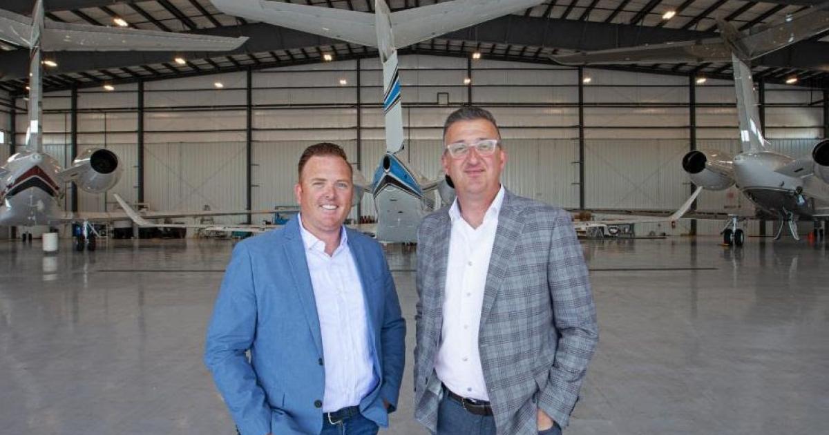 Robert Sherry, COO, James Prinzivalli, president, Executive Fliteways in hangar backdropped by business jets
