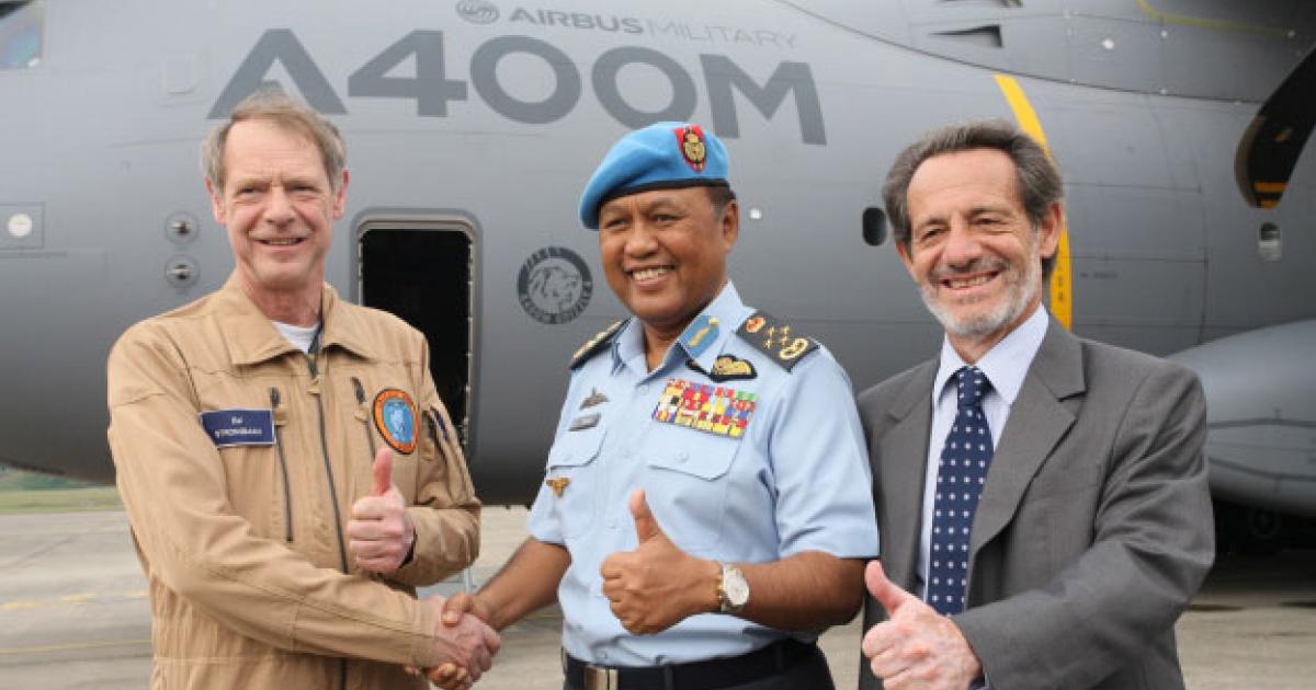 It’s all smiles and thumbs up in Malaysia, as Airbus Military chief test pilot Ed Strongman (left) and senior vice president Ignacio Alonso (right) greet the country’s air force commander, Gen. Rodzali Daud. 