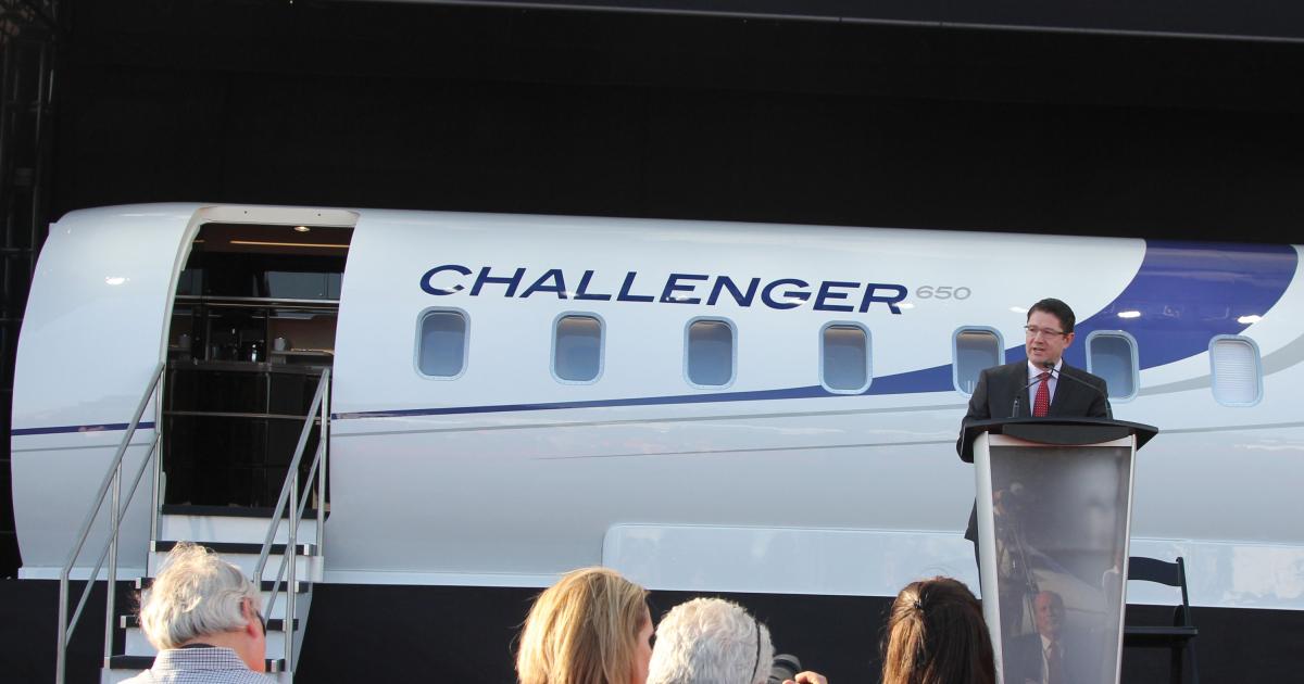 Eric Martel, the new president of Bombardier Business Aircraft, addresses a press gathering in front of the Challenger 650 cabin mockup. Bombardier launched the newest 600-series Challenger here at NBAA 2014 in Orlando, Florida.
