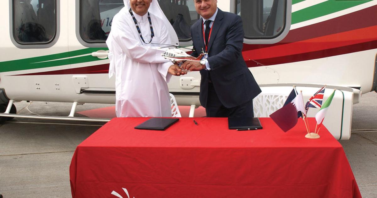 Gulf Helicopters CEO Mohamed Al Mohannadi and AgustaWestland CEO Daniele Romiti seal a deal at the Dubai Airshow for 15 AW189 helicopters.