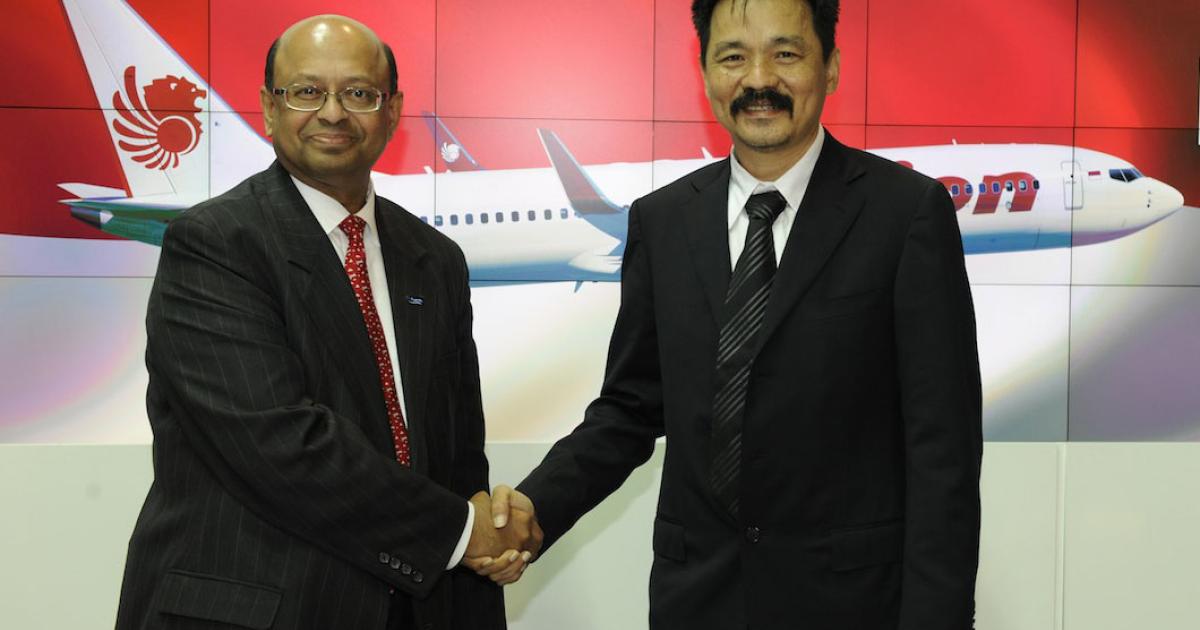 Dinesh Keskar (left), v-p of Asia Pacific and India sales for Boeing Commercial Airplane, shakes on a deal for 201 copies of the 737Max-9 with Rusdi Kirana, Lion Air president. (Photo: Mark Wagner)
